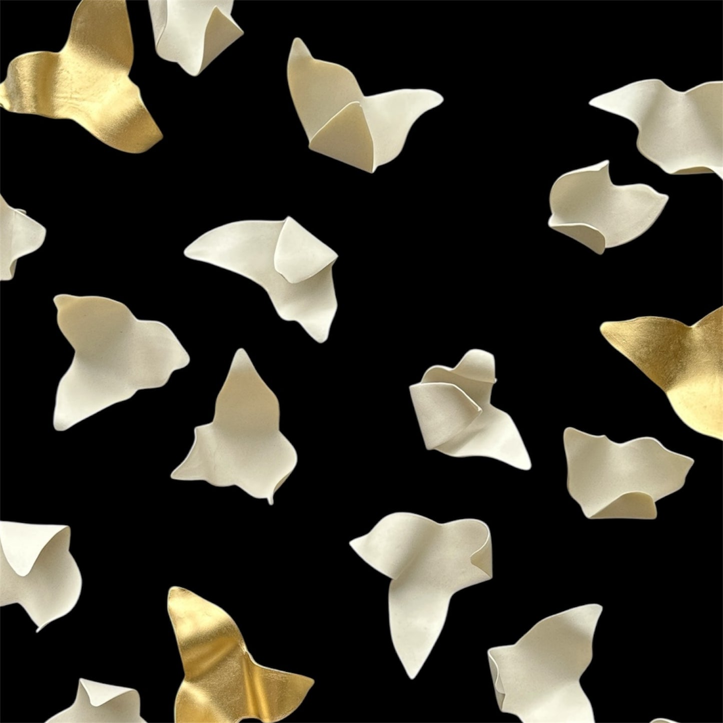 Pattern of gold and white leaves on a black background