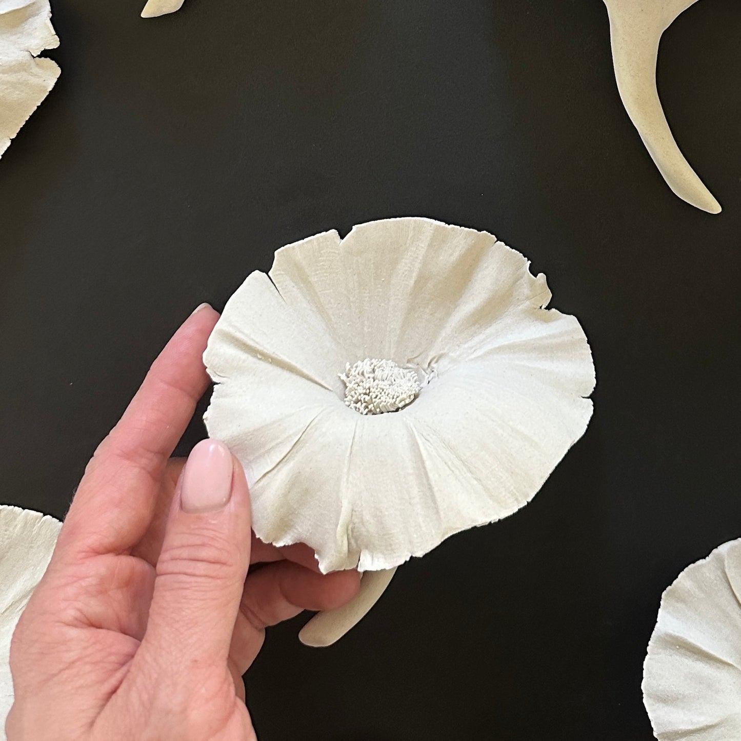 white ceramic flower wall decor