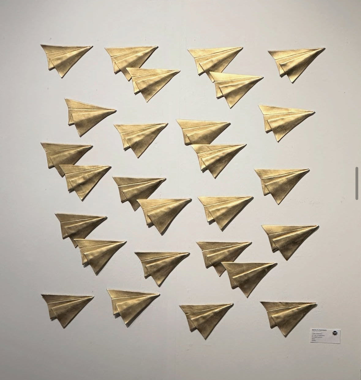 Minimalist wall sculpture made from hand-shaped ceramic panels in Seattle