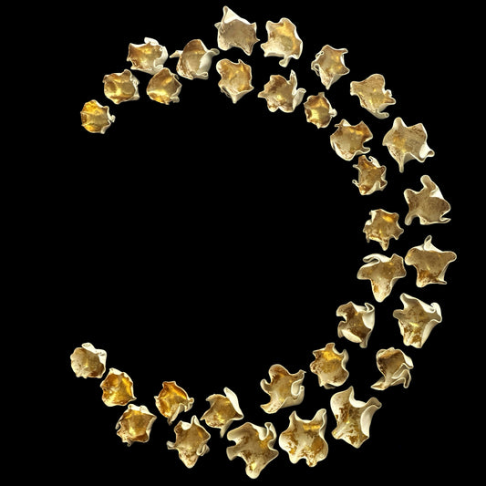 Gold star-shaped objects arranged in a curved pattern on a black background