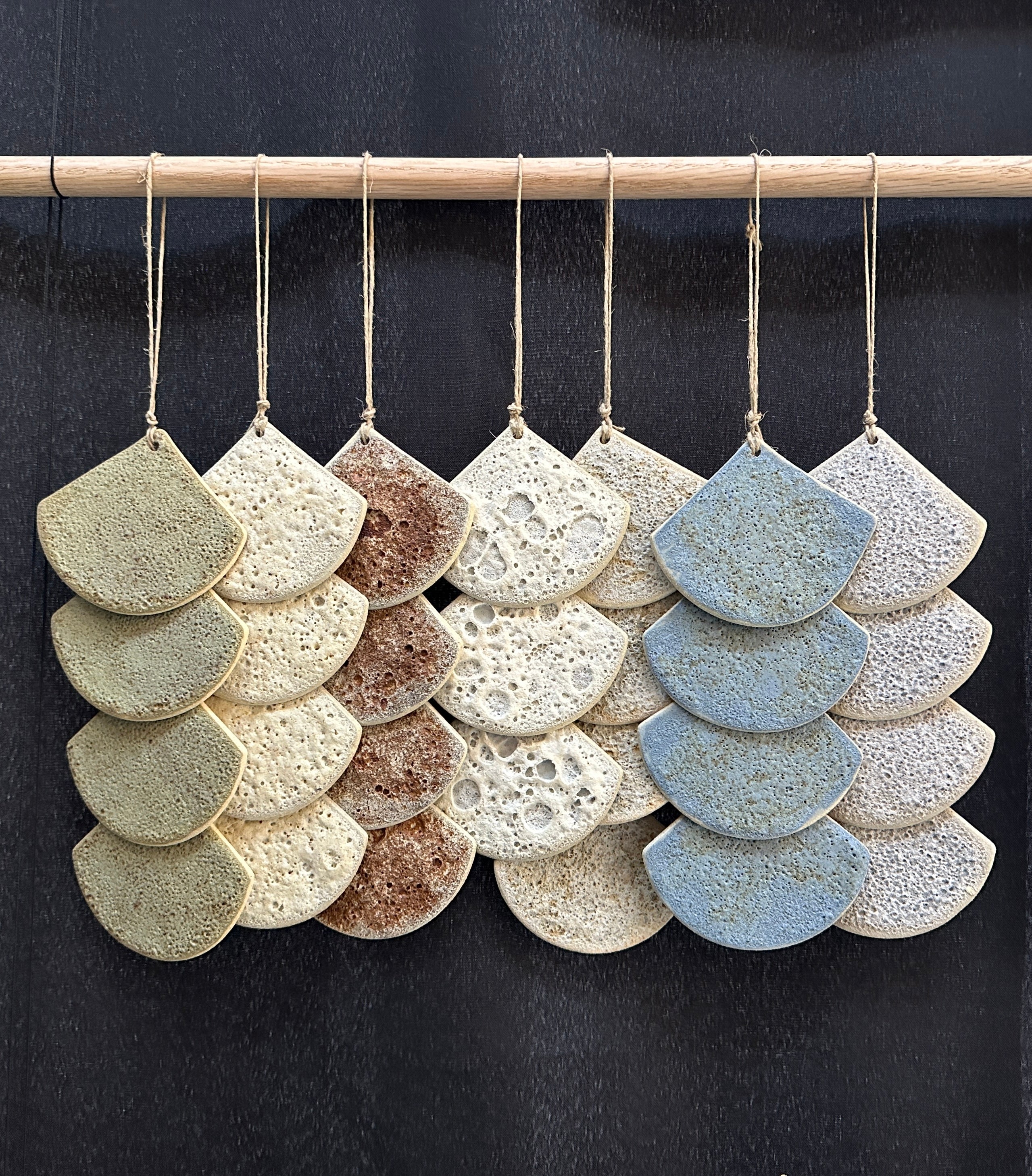 Sculptural ceramic wall panel featuring soft curves and a neutral glaze, ideal for contemporary spaces