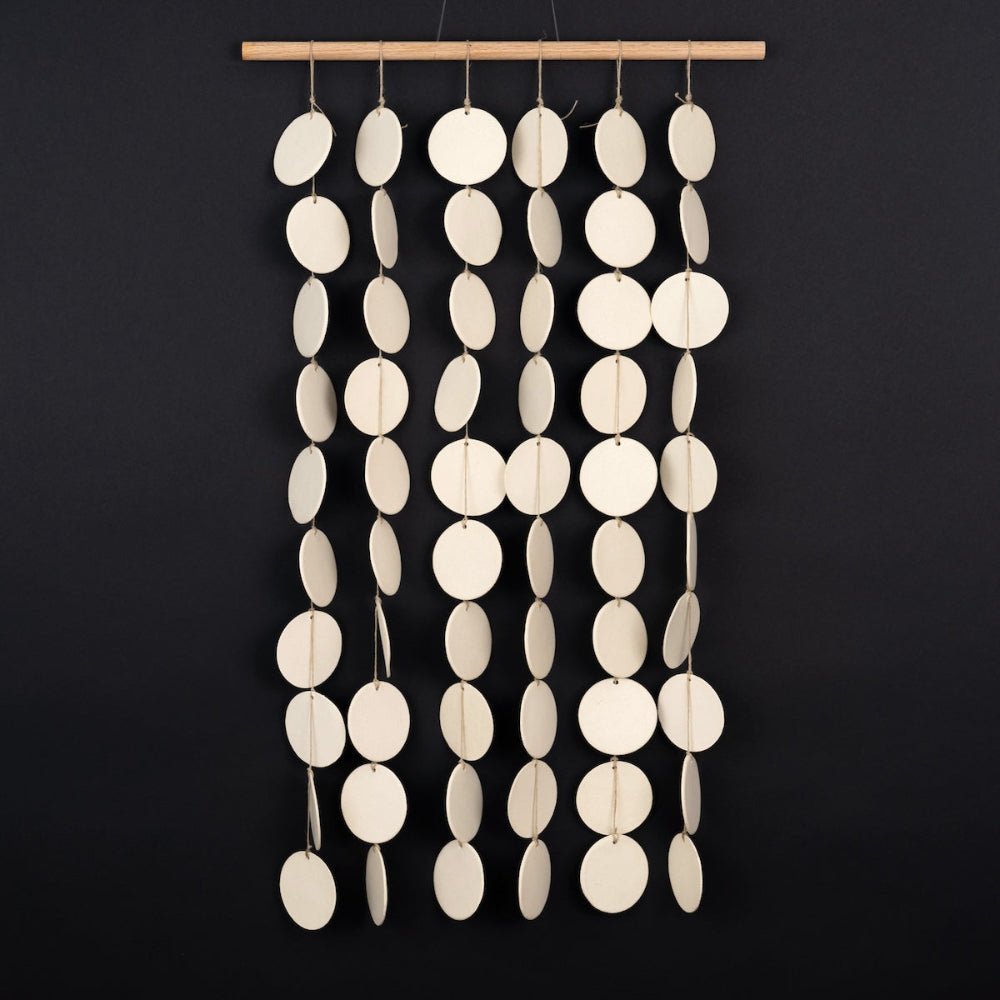 ceramic curtain panels mounted on wall, highlighting soft organic curves and handmade detail