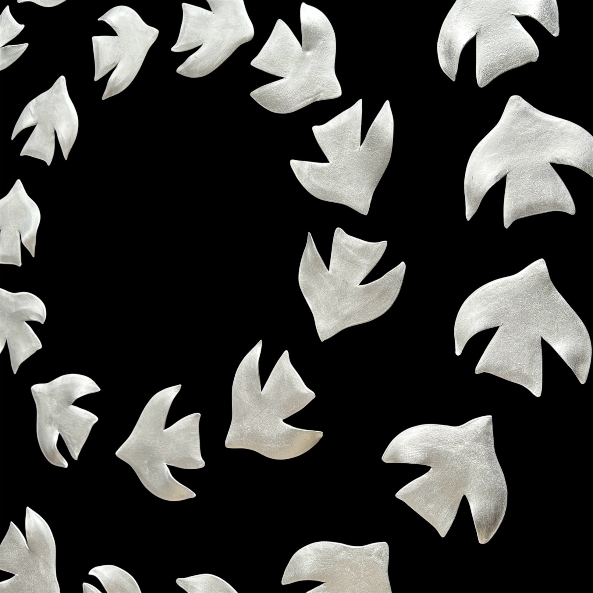 White bird-shaped wall decor on a black background