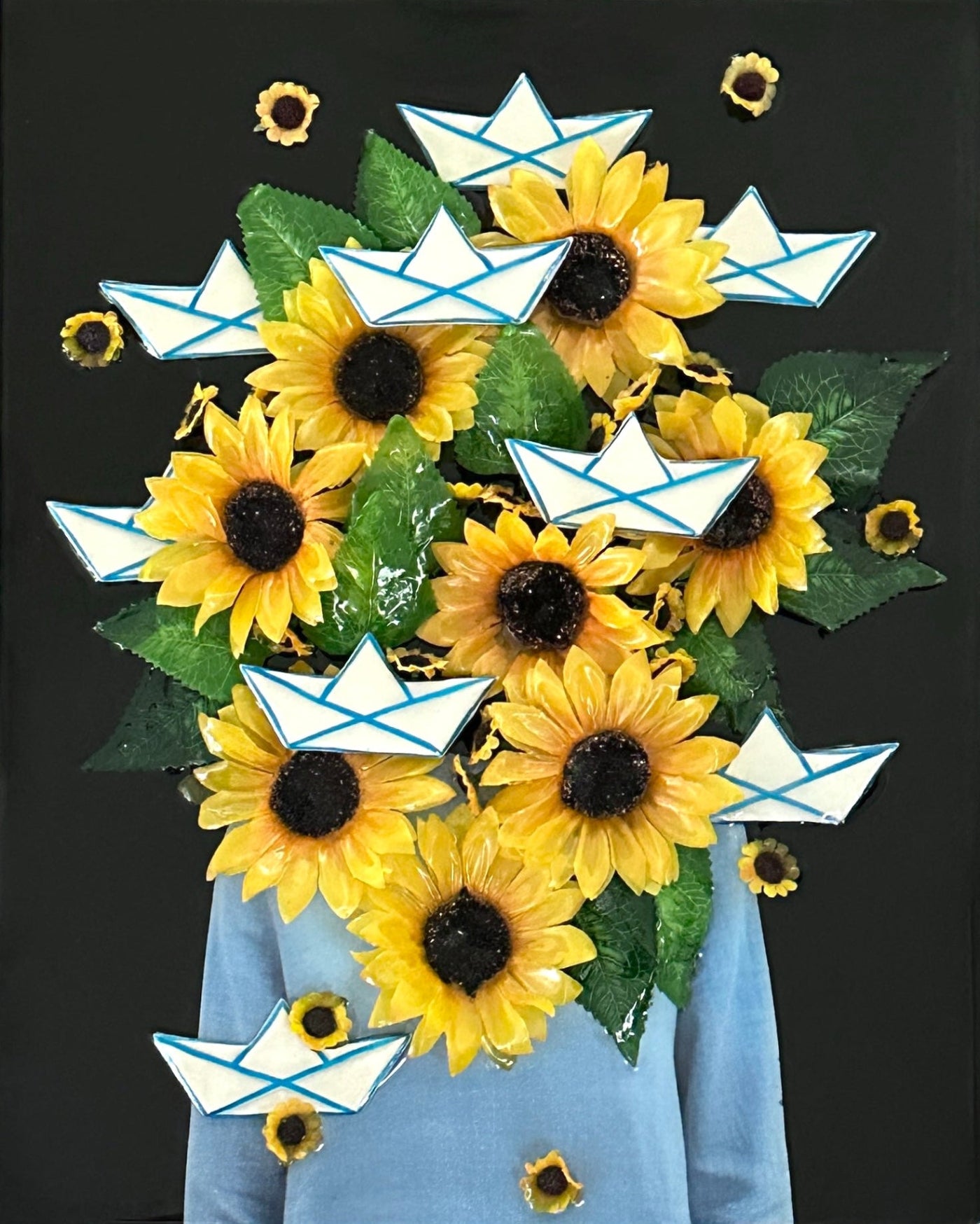 Textured mixed-media wall sculpture featuring ceramic shapes, layered collages, resin accents, and delicate silk flowers, displayed as interior wall art.