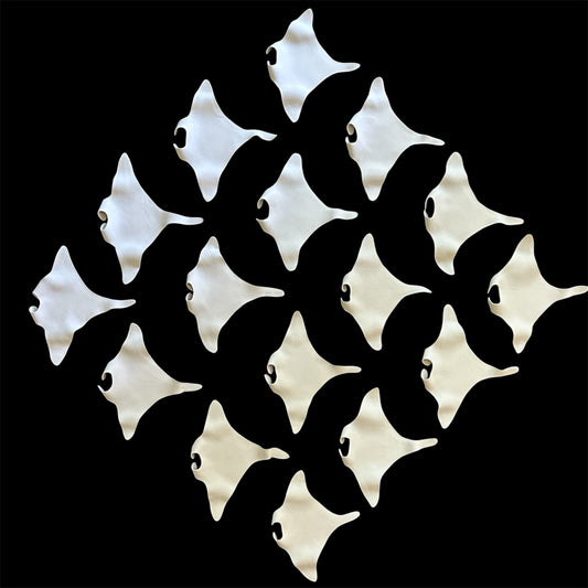 white ceramic manta rays on a black background