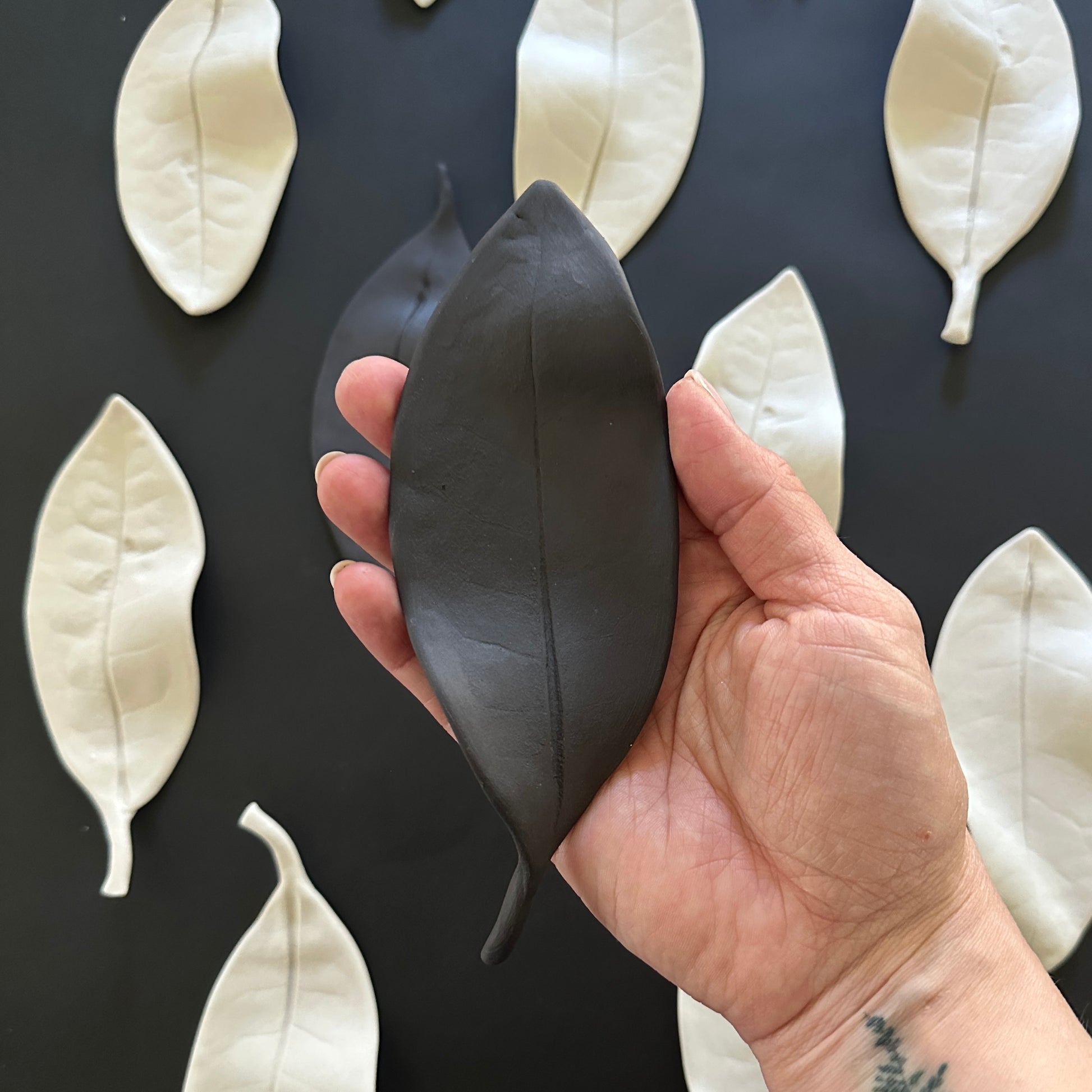 Black leaf wall installation