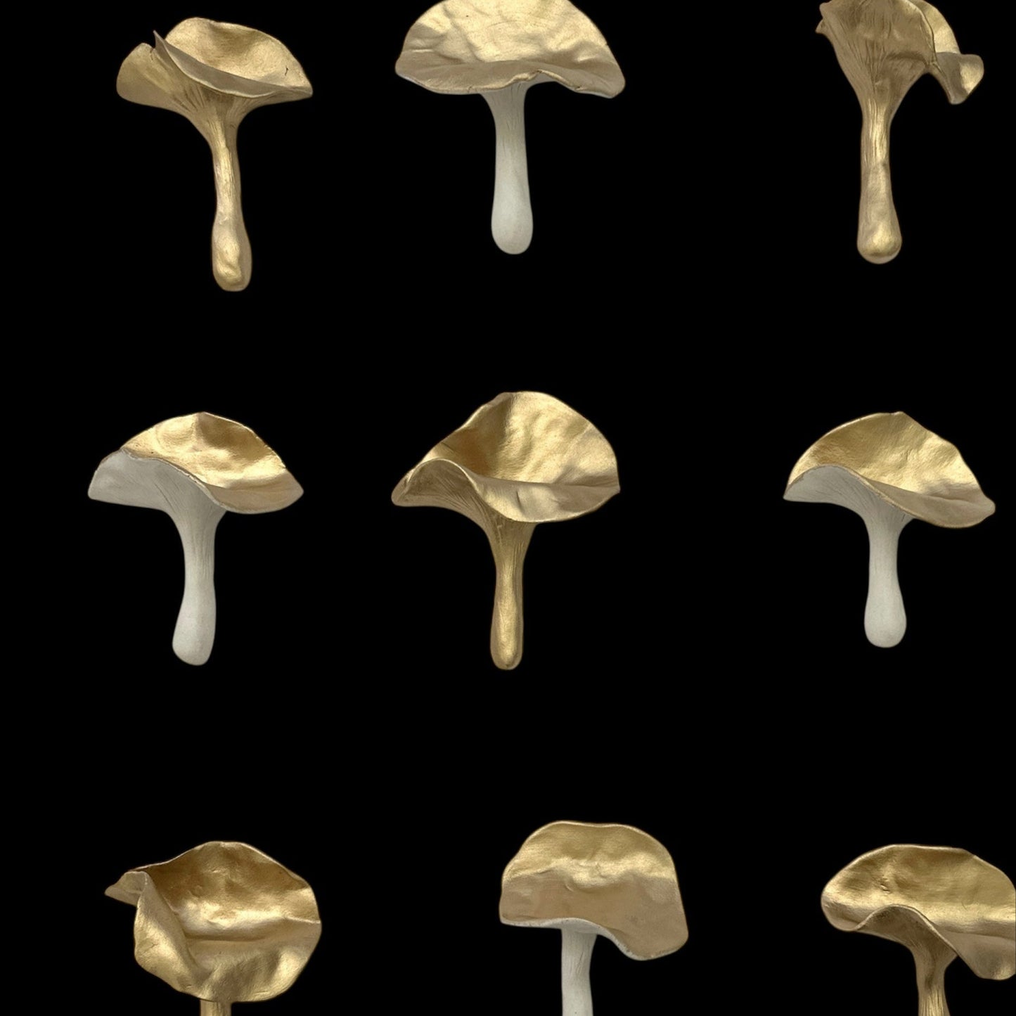 Pattern of ceramic gold mushrooms on a black background