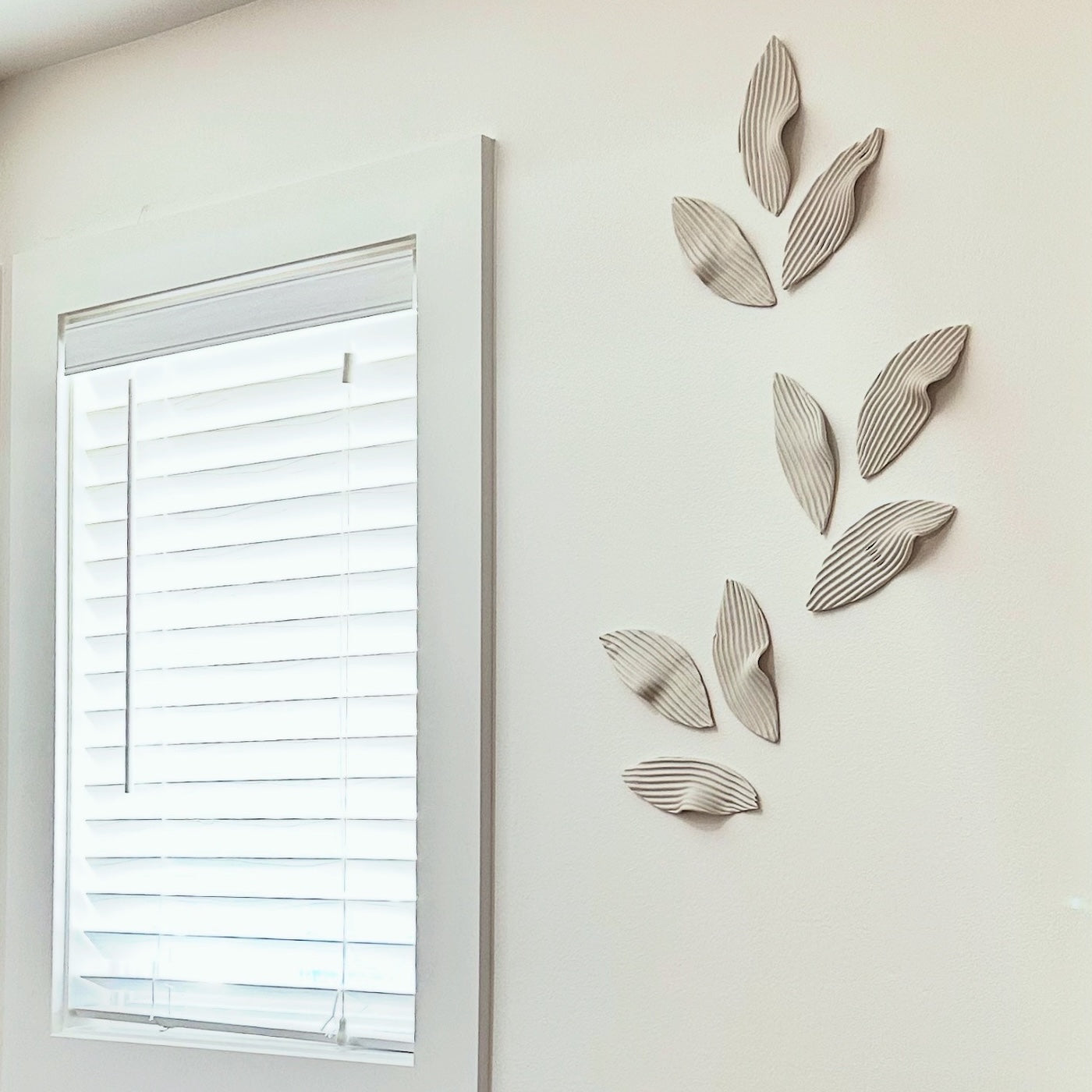 Ceramic wall decor above taupe sofa, Redmond, WA