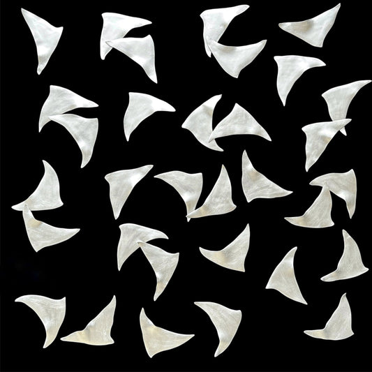 Silver kites arranged in a pattern on a black background