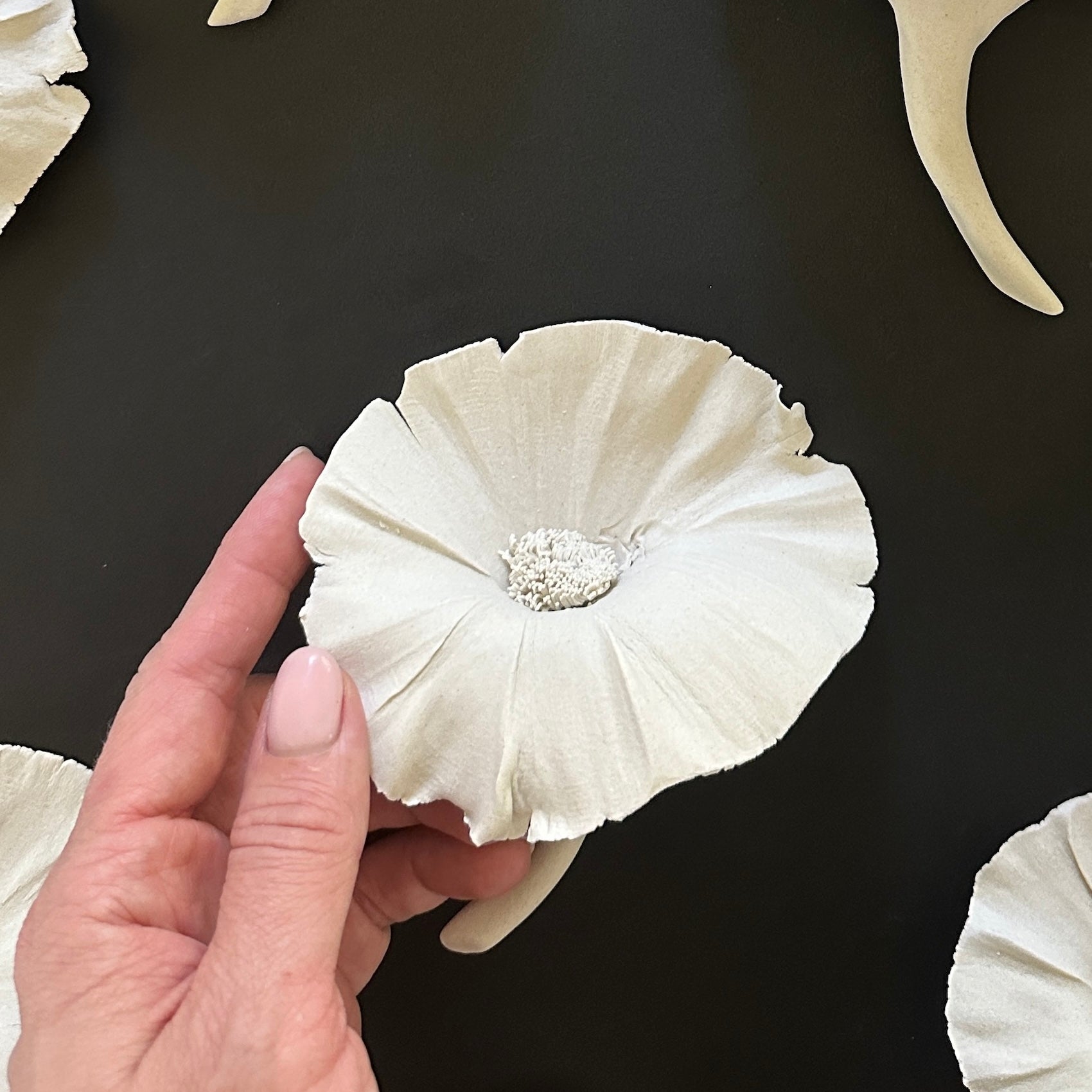 white ceramic flower wall decor
